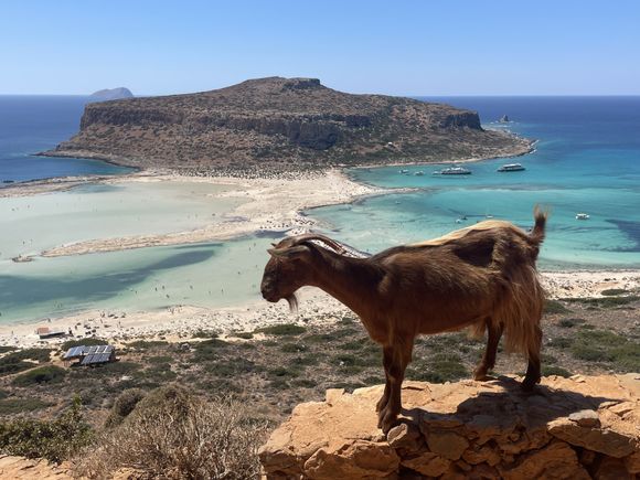 View from the hillside path above Balos showing the lagoon, sandbar, and open sea beyond