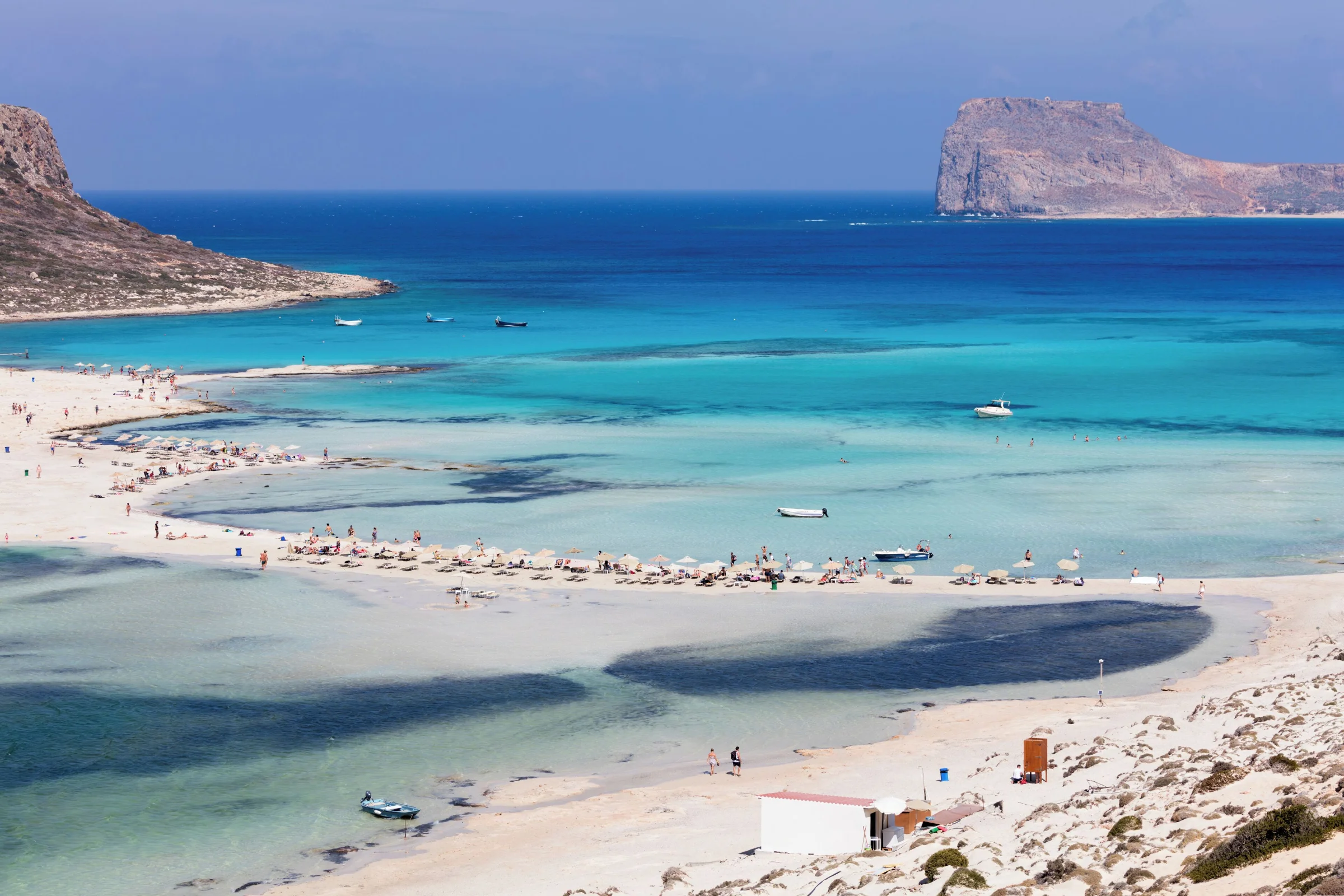 Balos Lagoon seen from above with the curving beach, turquoise water, and Gramvousa Peninsula in the background