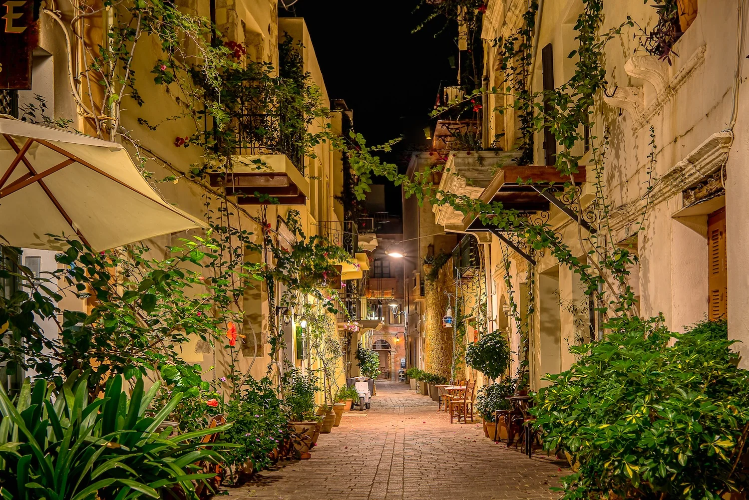 Evening view of Chania Venetian Harbour with illuminated restaurants