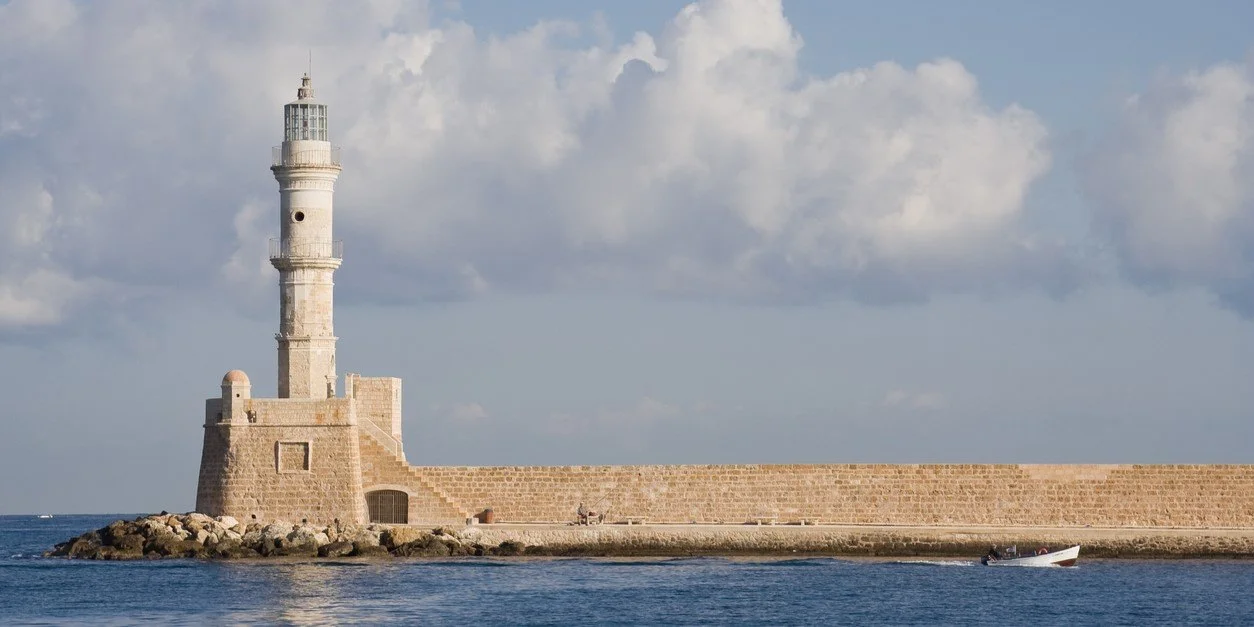 Historic lighthouse at the entrance of Chania Venetian Harbour in Crete