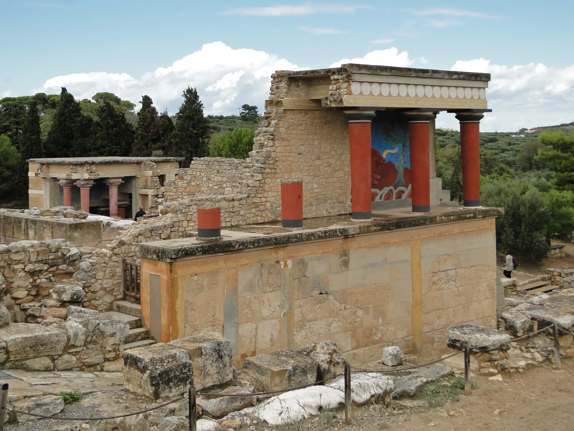Reconstructed north entrance of the Palace of Knossos with restored Minoan columns and fresco reproduction, Crete