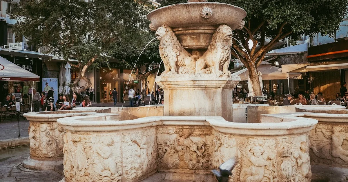 Heraklion Old Town and Morosini Fountain Alt text: Pedestrian street in Heraklion Old Town with the Morosini Fountain at Lion